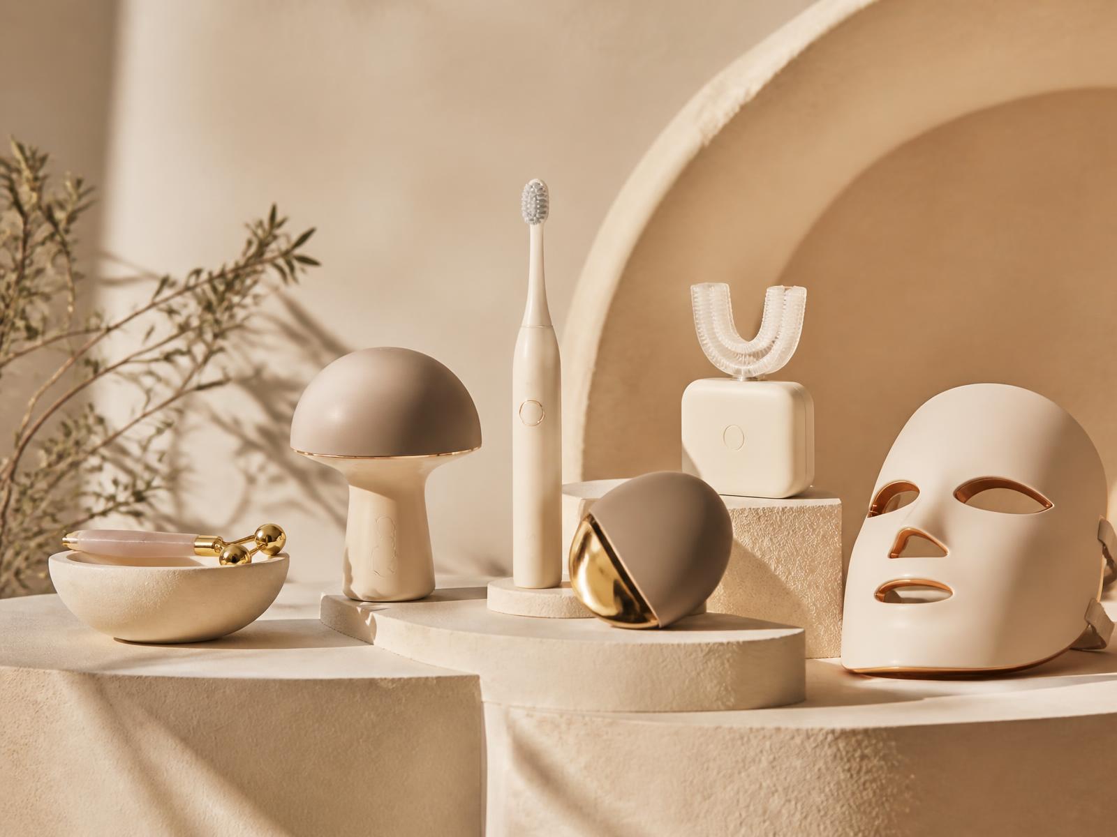 Curated GlowNest beauty and wellness products arranged on warm sand pedestals